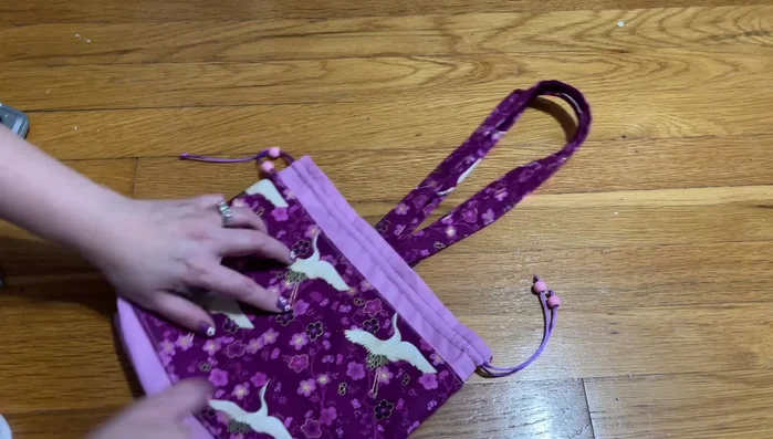 Add drawstrings and buttons.