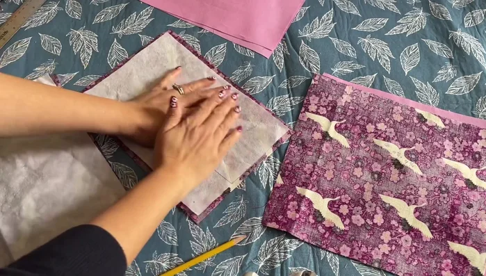 Iron interfacing onto the wrong side of the solid fabric pieces, leaving a 0.25-inch seam allowance.