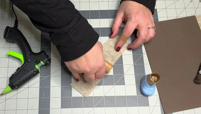 Glue the felt only to the bottom of the booty, not the top portion, to create a tight seam. Use embroidery thread to lace up the front of the boot.