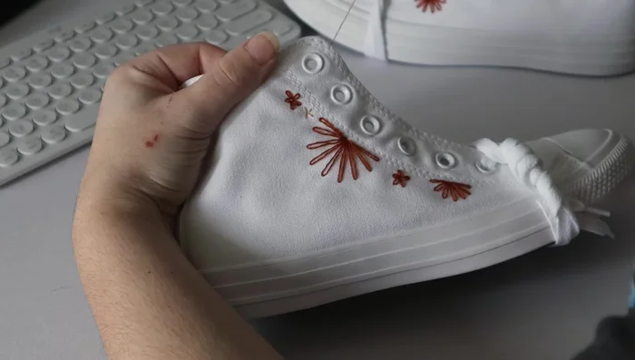 Embroider roses using the woven wheel stitch.