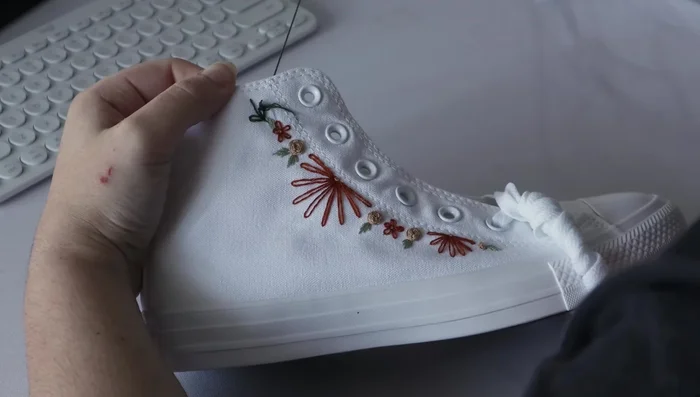 Add vines using lazy daisy stitches.