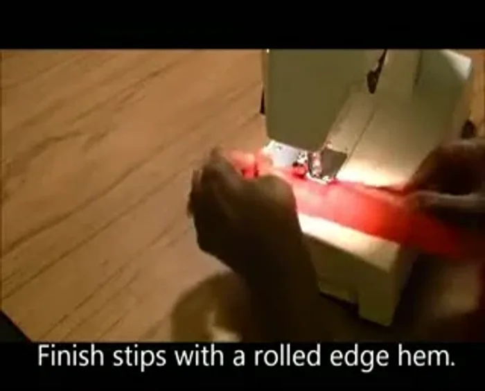 Finish the edges of the fabric strip using a rolled hem to prevent fraying.