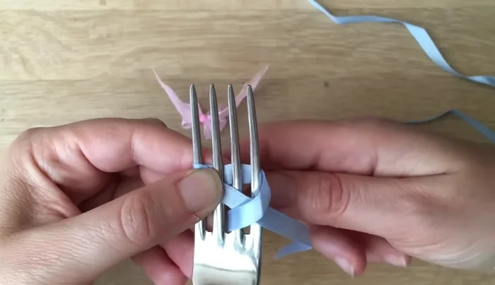 Bring the top ribbon to the back and then back up, keeping it neat and untwisted.