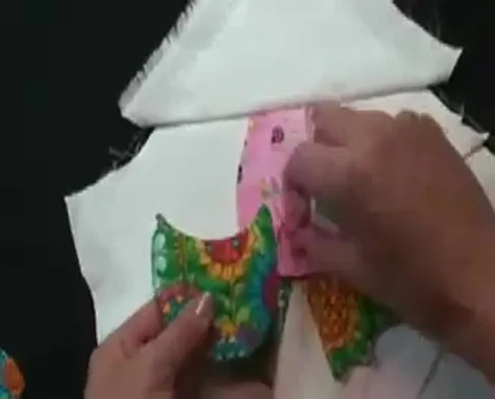 Sew all the way around, turn it over, and hand close the opening. Place the hands behind the lining; put the hands under and blind stitch around the outside, reinforcing the corners.