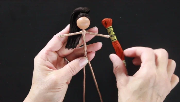 Prepare the fairy doll's clothing. Wrap embroidery floss around the doll's arms for puffed sleeves and create simple shorts.