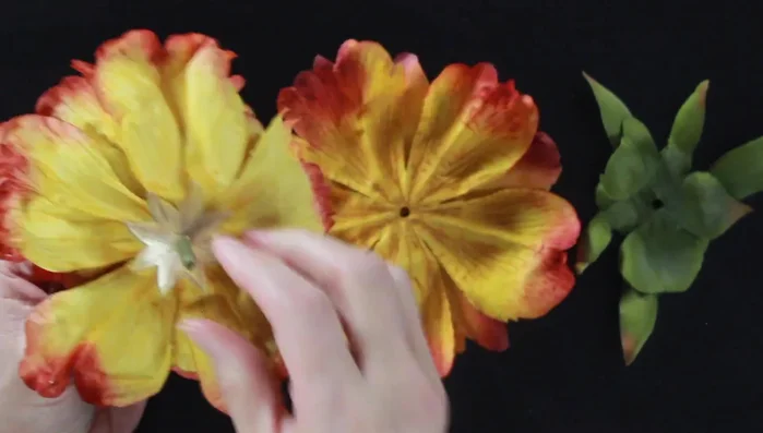 Cut an 'X' into the center of each petal to facilitate attaching them around the doll's waist.