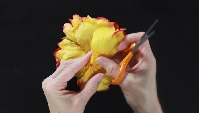 Cut an 'X' into the center of each petal to facilitate attaching them around the doll's waist.