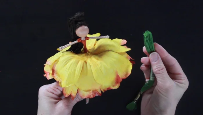 Incorporate additional embellishments. Tuck small leaves and foliage underneath and on top of the flower petals for added detail and visual interest.