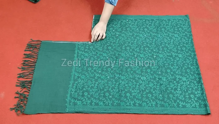 Make a small diagonal cut at the shawl's corner, fold and stitch the raw edges (1/4 inch seam allowance).