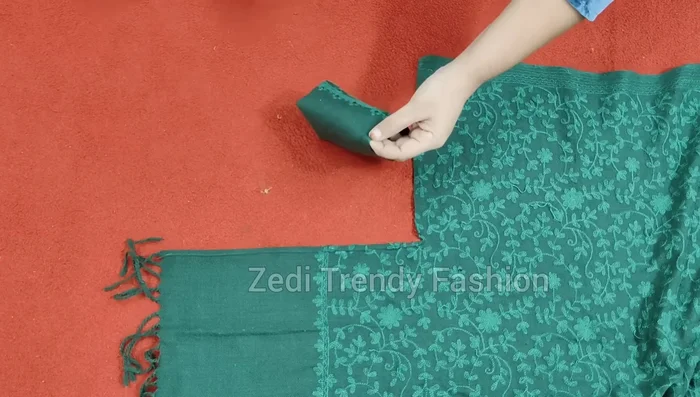 Attach the cuffs to the shawl corners, stitching around the cuff's curve and securing any excess fabric.