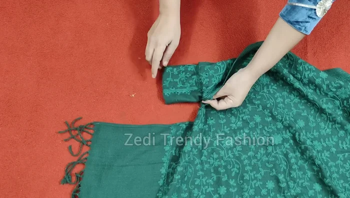 Attach the cuffs to the shawl corners, stitching around the cuff's curve and securing any excess fabric.