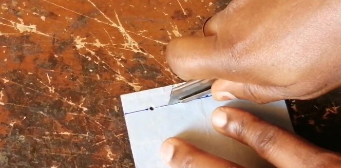 Open the punched holes using a utility knife, carefully following the marked lines.