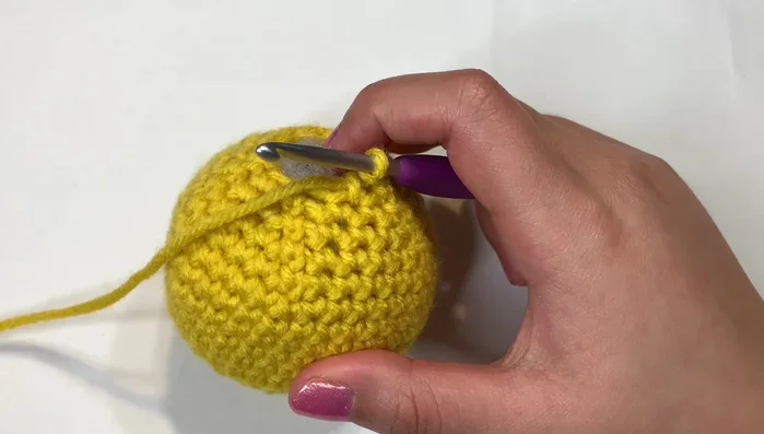 Final Rounds: Continue invisible decreases until desired tightness. Secure yarn and weave in ends. Attach to wooden ring.