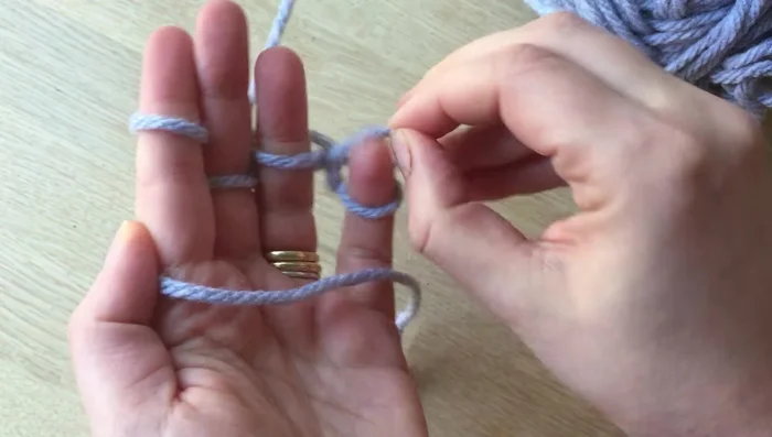 Cut a long piece of wool and weave it through each loop to secure the knitted piece. Pull tight.